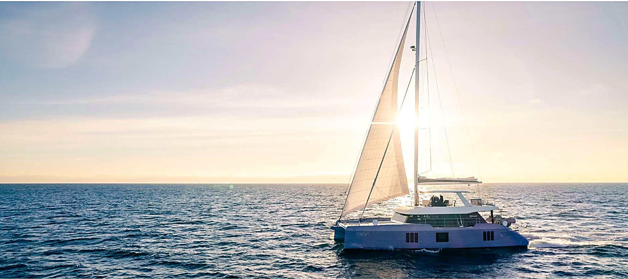 Sunreef 70 sailing catamaran AGATA BLU under sail at sunset